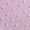 Geometric arrangement of white sugar cubes on a pastel pink surface.