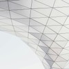 Low angle view of a modern geometric architectural structure with triangle patterns.